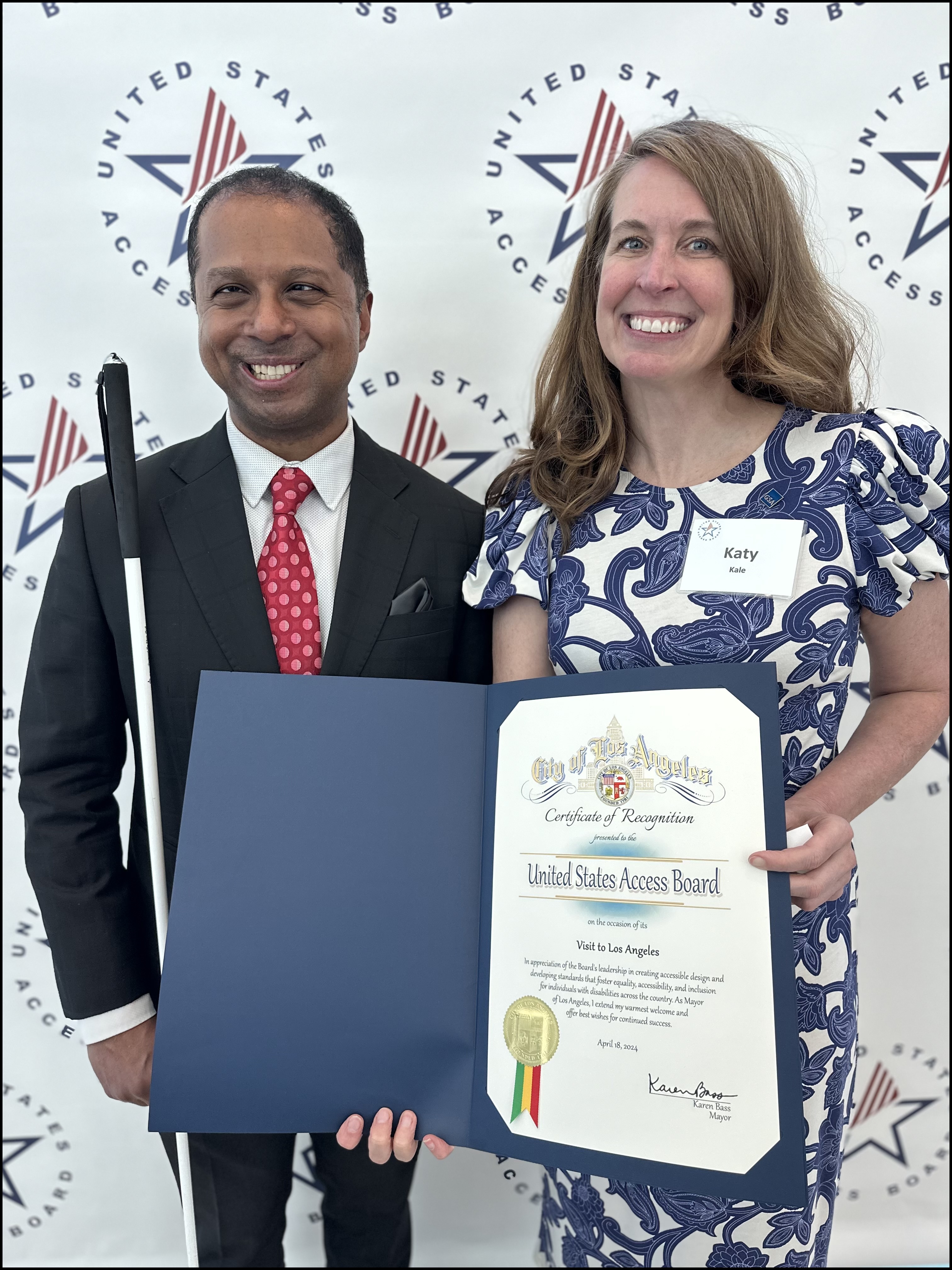 Access Board Vice-Chair Katy Kale and Executive Director Sachin Pavithran hold a Certificate of Recognition from Los Angeles Mayor Karen Bass.